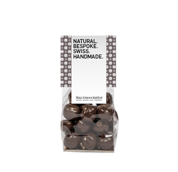 Geröstete und caramelisierte Haselnüsse umhüllt von dunkler Grand Cru Schokolade in einem Säckli - Max Chocolatier