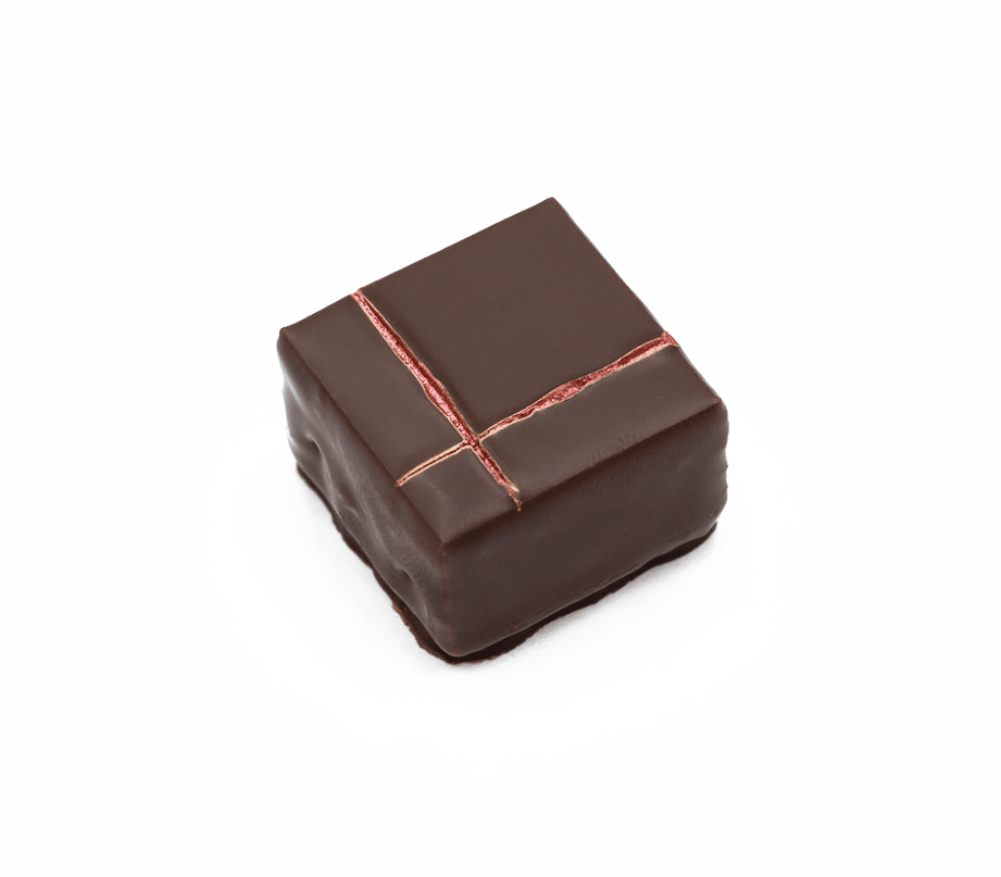 Handgemachte Schnittpraline mit Zitronenmelisse und Waldfrucht - überzogen mit Milchschokolade - Max Chocolatier